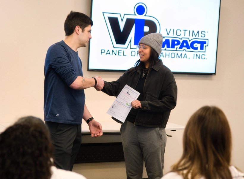 Woman receivs certificate from Victims' Impact Panel